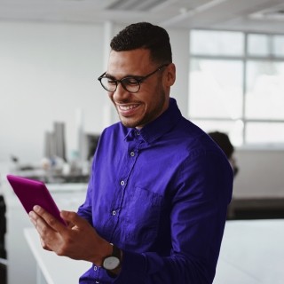 man looking at phone happily